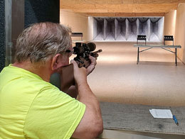 Two men shooting air pistol silhouettes