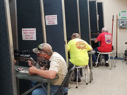 Two men shooting air pistol silhouettes